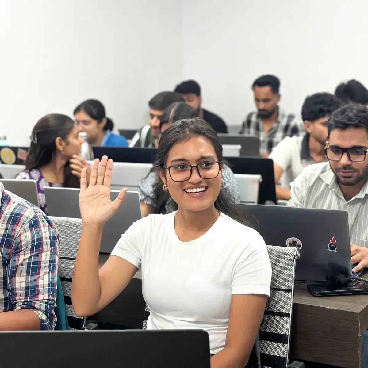 A learner raising a hand in a BrillicaNext class
